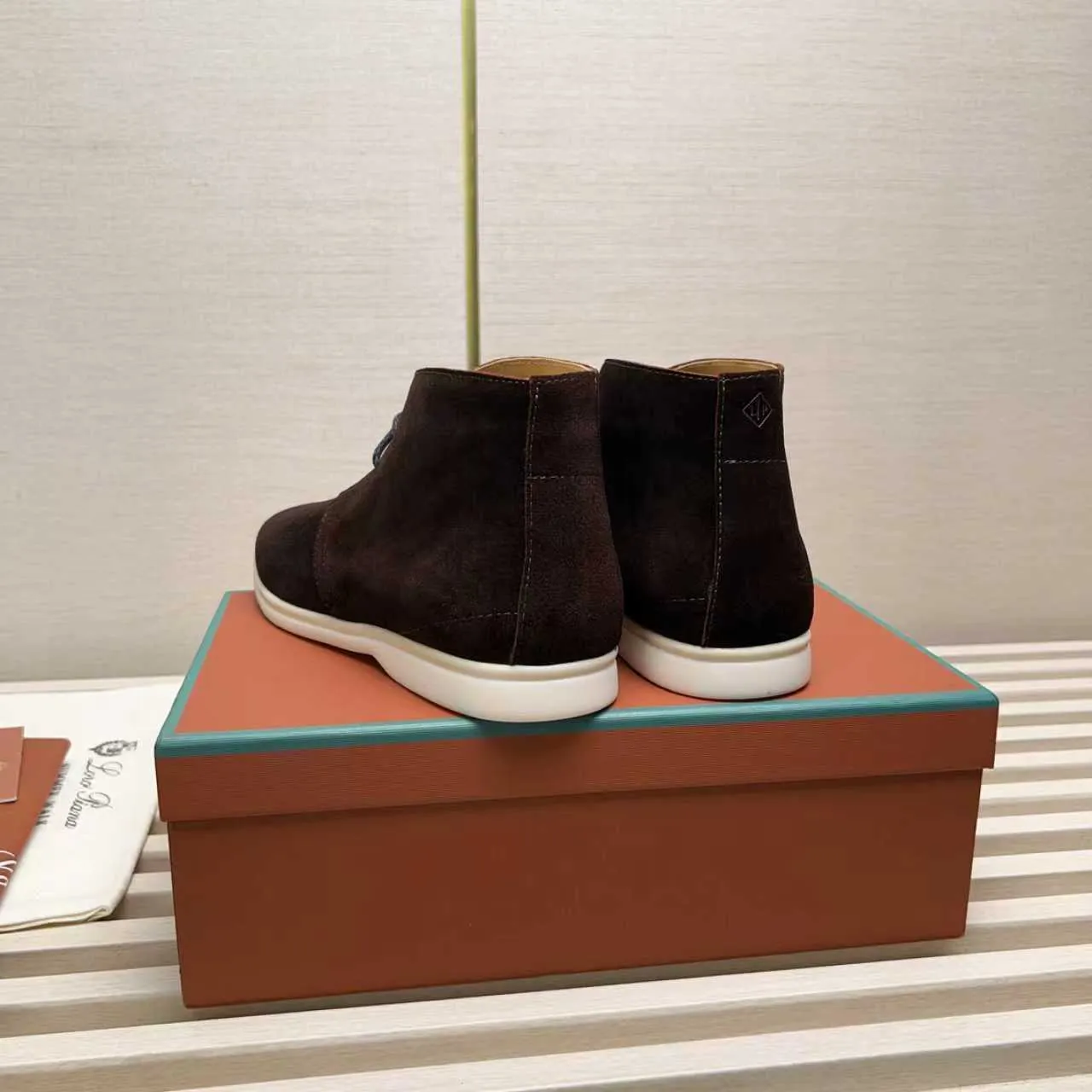 Men's Shoes 💰420 Loro Piana reimagines the desert boot—a modern, comfortable interpretation of a classic 1940s style. Crafted from suede calfskin, it exudes elegance. The tight texture of suede calfskin is not only durable but also looks casual and sophisticated. Add a timeless piece to your shoe collection, harmoniously blending comfort, style and Loro Piana's heritage of craftsmanship. Acetate satin detail on the inside White sole with LP lettering for added traction Space for a personalized signature on the heel Tonal suede trim Upper: 100% cow split suede Sole: 100% Rubber lining: Cow leather